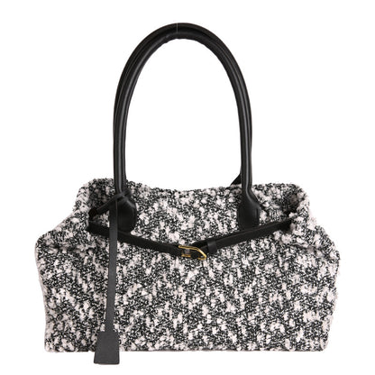 Black and white patterned handbag with a black handle on a white background