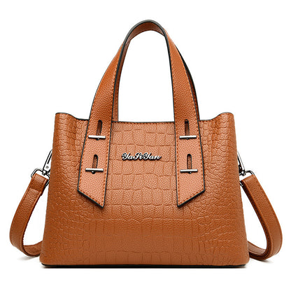 Brown handbag with a visible brand logo on a white background