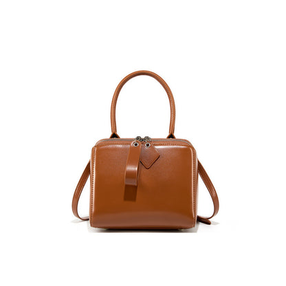 Brown leather handbag on a white background