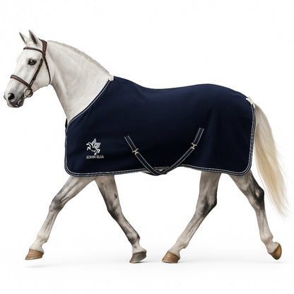 Horse wearing a navy blanket with a visible brand logo on a white background