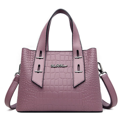 Purple handbag with a visible brand logo on a white background