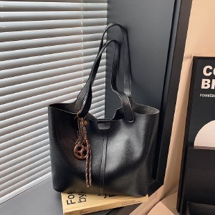 Black handbag on a surface with a blurred background