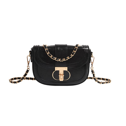 Black handbag with gold chain strap on a white background